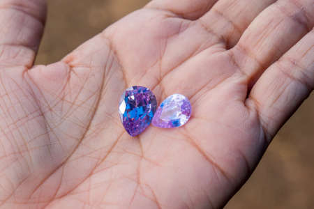 Beautiful bright purple gemstone iin hand