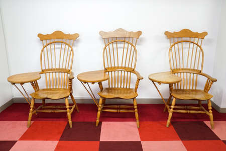 wooden vintage armchair with white wallの写真素材