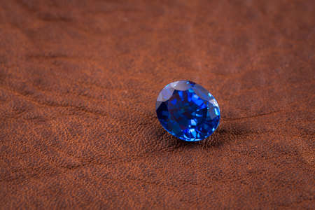 Blue sapphire on leather leather backgroundの写真素材