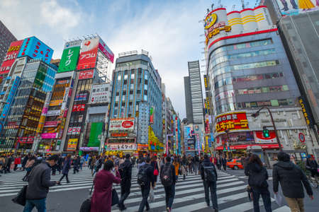 Tokyo, Japan - 5 March, 2018: Crowds of people at a busy crossing in Shinjuku at twilight on 5 March, 2018 in Tokyo, Japanのeditorial素材