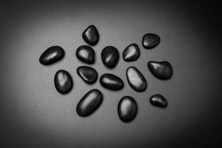 Pile black rocks on black background and texture, top viewの写真素材