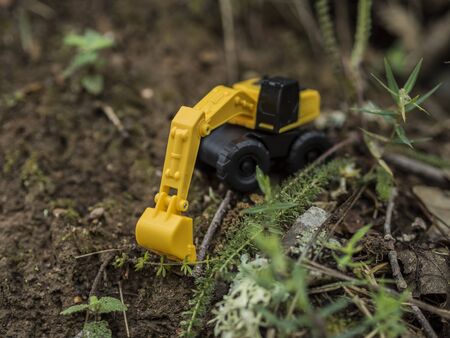 Toy construction machinery working on an excavation