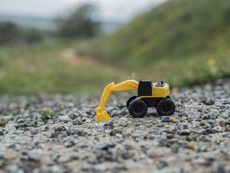 Toy construction machinery working on an excavation