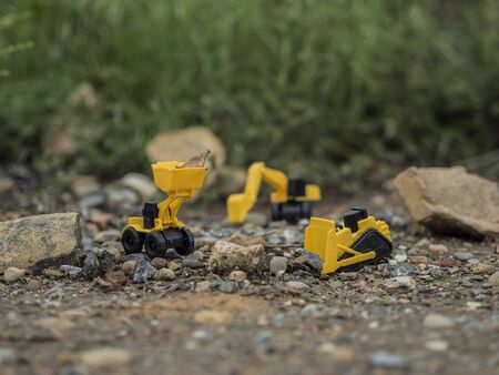 Toy construction machinery working on an excavation