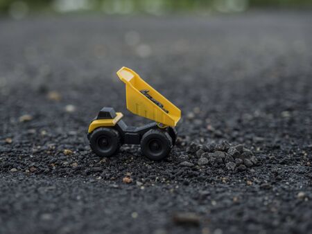 Toy construction machinery working on an excavation