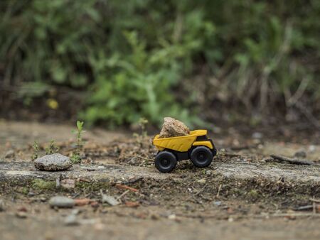 Toy construction machinery working on an excavationの写真素材