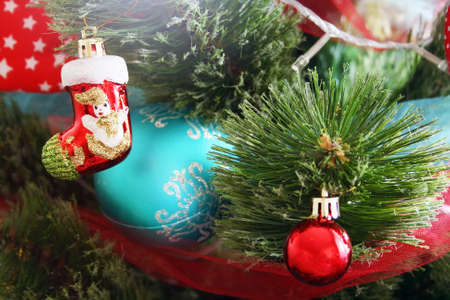 The artificial Christmas tree is decorated with blue and red garlands, balls and toysの写真素材