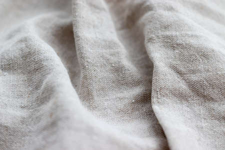 Natural linen fabric texture. Rough crumpled burlap background. Selective focus. Closeup viewの写真素材