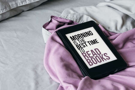A modern e-reader electronic book with text on screen - morning is the best time to read books - on...