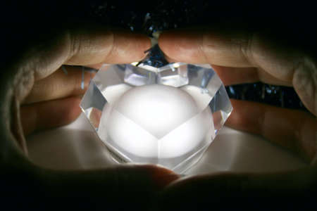 Hands guard a glowing heartの写真素材