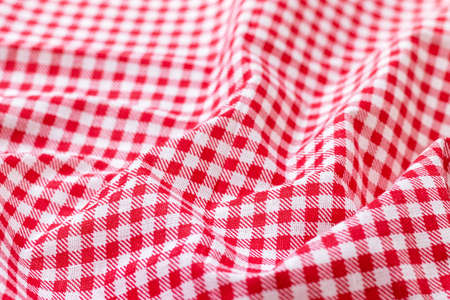 Red and white checkered fabric texture. Crumpled bright colored cotton background. Selective focus. Closeup viewの写真素材