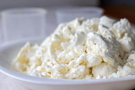 A white plate filled with cottage cheese. Closeup view. Selective focusの写真素材