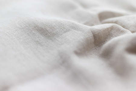 Natural linen fabric texture. Rough crumpled burlap background. Selective focus. Closeup viewの写真素材