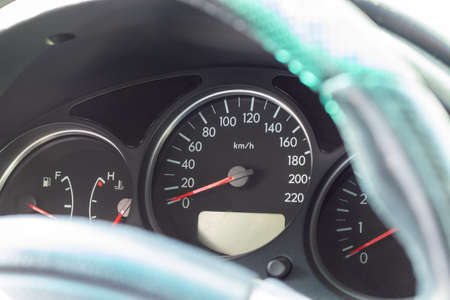 Car dashboard with speedometer and fuel level gauge. Closeup view. Selective focusの写真素材