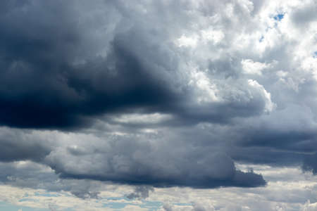 Dramatic sky with gray white blue clouds. Overcast and cloudy to rainの写真素材