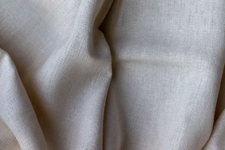 Natural linen fabric texture. Rough crumpled burlap background. Selective focus. Closeup viewの写真素材