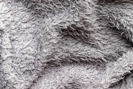 Gray fluffy fabric background. Warm sweater textureの写真素材