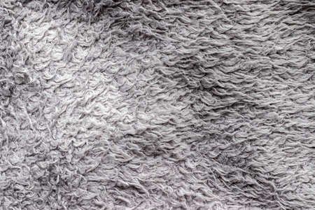 Gray fluffy fabric background. Warm sweater textureの写真素材