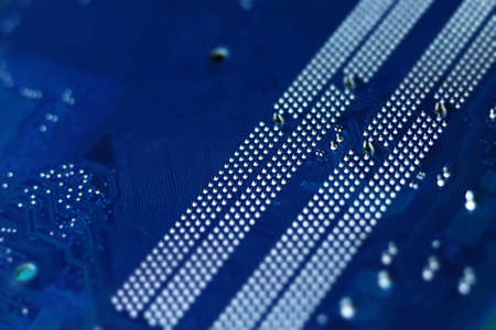 Dark blue computer motherboard closeup in tilt shift style. Selective focus, defocused