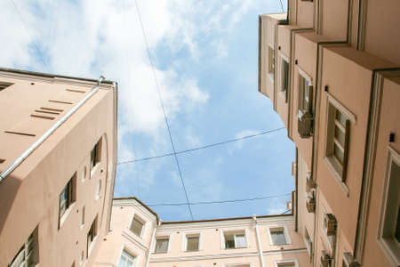 View of the blue sky from the yard-well
