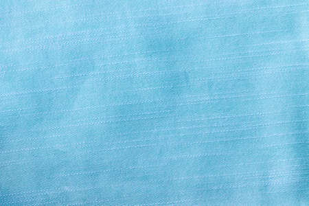 Soft blue, turquoise cotton fabric texture background with stitched diagonal stripes