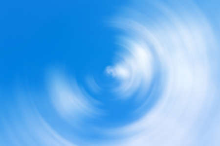 Blurred gradient radial motion light blue and white background. Mixed cloudy sky circular textureの写真素材
