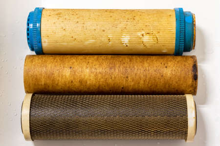 Used dirty replaceable filter cartridges for drinking water purification. Water filtration RO (reverse osmosis) system. Activated carbon block and ultra filtration membraneの写真素材