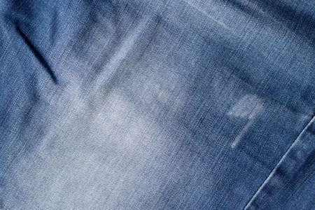 Blue jeans fabric texture. Distressed denim with seam background
