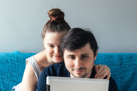 Man and woman with a tablet. Smiling caucasian couple looking at tablet with interestの写真素材
