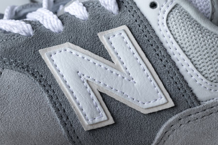 New Balance 574 light gray sneakers logo closeup. Suede and mesh walking, casual sport shoes. Illustrative editorial photoのeditorial素材