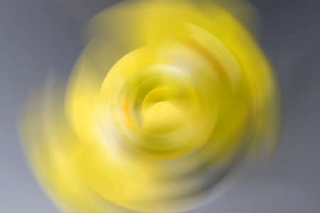Blurred yellow gray gradient, radial motion background. Abstract circular texture. Color trend of the year 2021の写真素材