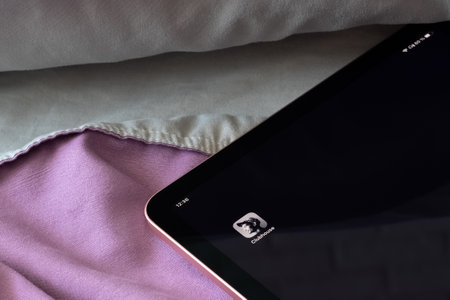 Clubhouse app drop in audio chat application on digital tablet on a gray and purple textile bedding. Kyiv, Ukraine - February 16, 2021のeditorial素材