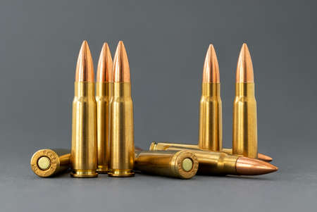 Bullets on gray background. Cartridges 7.62 caliber for assault rifle closeup