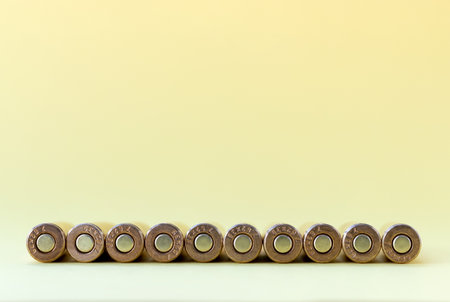 Bullets bottom on yellow background. Cartridges 7.62 caliber for  assault rifle closeup with copy spaceの写真素材