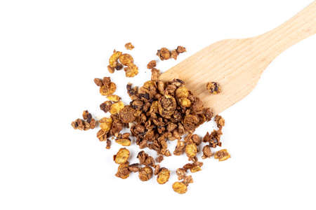 Organic homemade roasted granola cereal pile with oats, flax, almonds, chocolate with wooden spatula or spoon isolated on white background. Top view muesliの写真素材