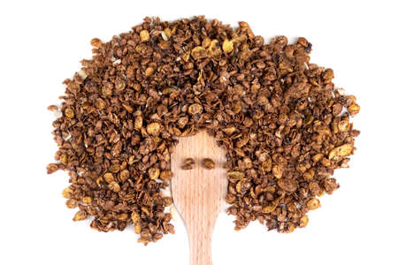 Organic homemade roasted granola cereal with oats, flax, almonds, chocolate with wooden spatula isolated on white background. Top view muesliの写真素材