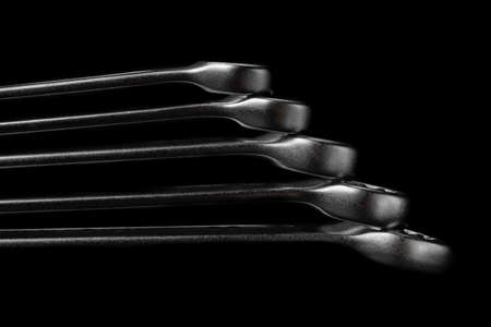 Five steel wrenches isolated on black background closeup. Beautiful photo for a poster in a car...