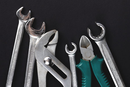 Work tools on black, dark gray background. Top view, flat lay