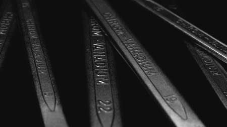 Wrenches, chrom vanadium spanners on black, dark background, steel hand work tools closeup, abstract...