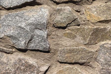 Rough uneven granite stone wall background texture