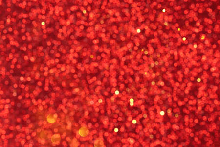 Red and golden sparkling glitter bokeh background, christmas abstract defocused texture. Holiday...