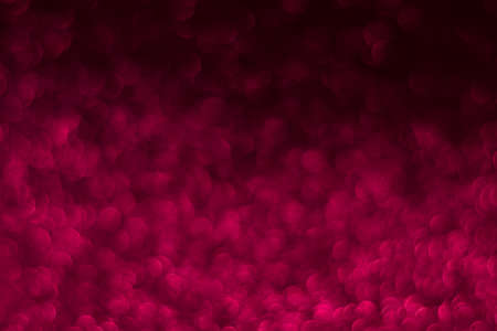 Pink sparkling glitter bokeh background, christmas abstract defocused texture. Holiday lights