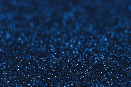 Blue sparkling glitter bokeh background, christmas abstract defocused texture. Holiday lightsの写真素材