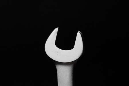 Wrench on black background, steel hand work toolの写真素材