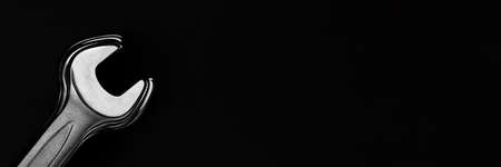 Steel wrenches on black background. Wide panoramic banner with copy spaceの写真素材