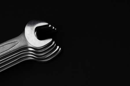 Steel wrenches on black background. Beautiful photo for poster in car workshop or loft apartmentの写真素材