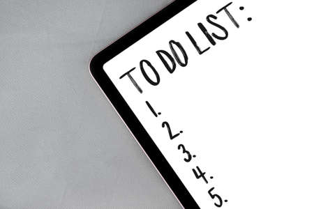 Digital tablet with to do list on gray fabric, textile background with copy spaceの写真素材