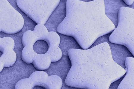 Trendy very peri color of the year 2022, violet blue, lavender baked shortbread cookies in the form...