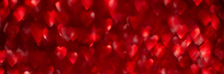 Red hearts, sparkling glitter bokeh background texture. Holiday valentines day lights. Abstract defocused header. Wide screen wallpaper. Panoramic web banner with copy space for designの写真素材