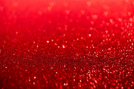 Red hearts, sparkling glitter bokeh background, valentines day abstract defocused textureの写真素材